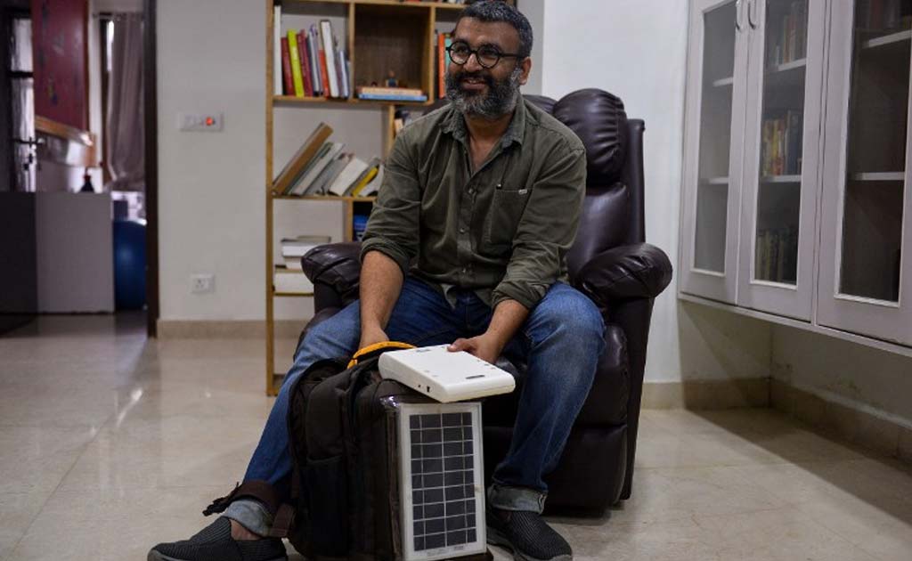 Biomedical engineer Kanav Kahoi speaks holding his invention 'Swasthya Slate' at his home in New Delhi.